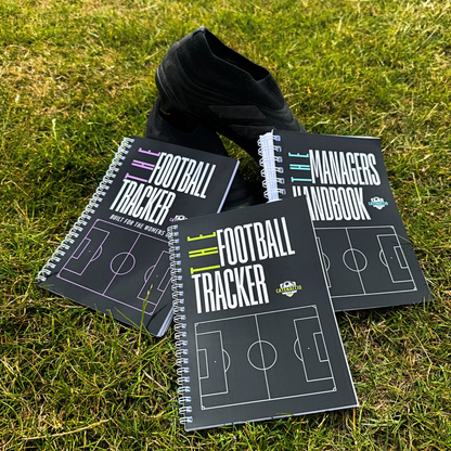 The football trackers and managers handbook on a pitch